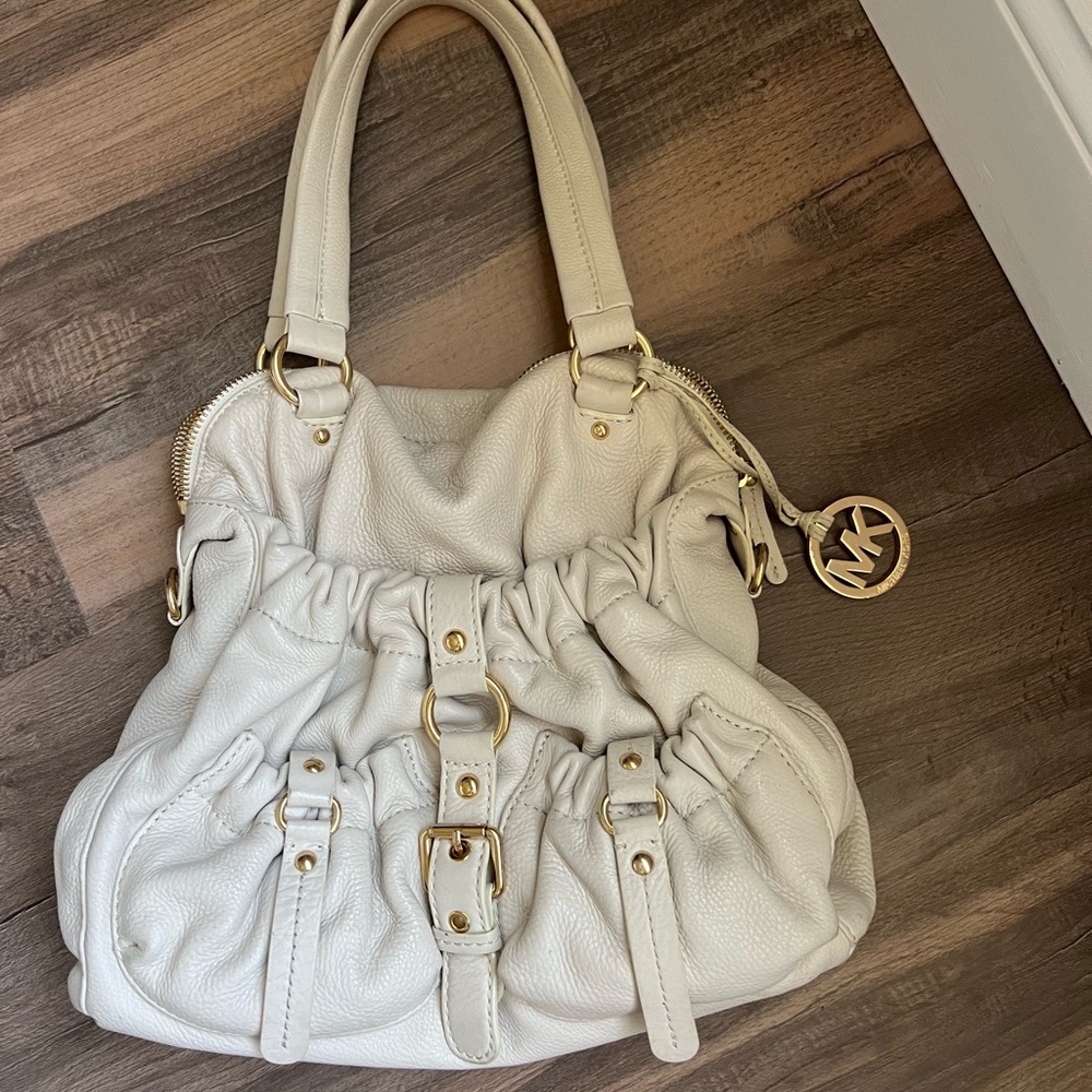 Cream color, perfect for summer Michael Kors purse with gold accents.